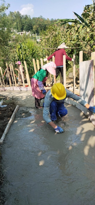 工人们正在给沟渠铺水泥。